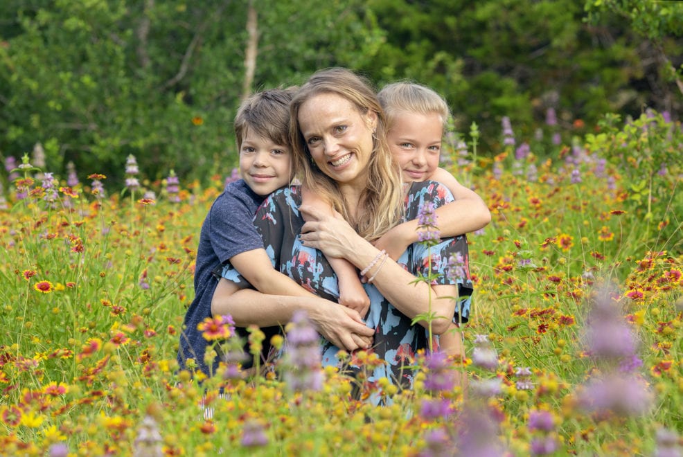 Family of three in wildflower at St. Edwards Park in Austin, Texas