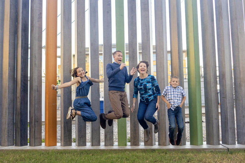 family jumping during their photo session downtown austin