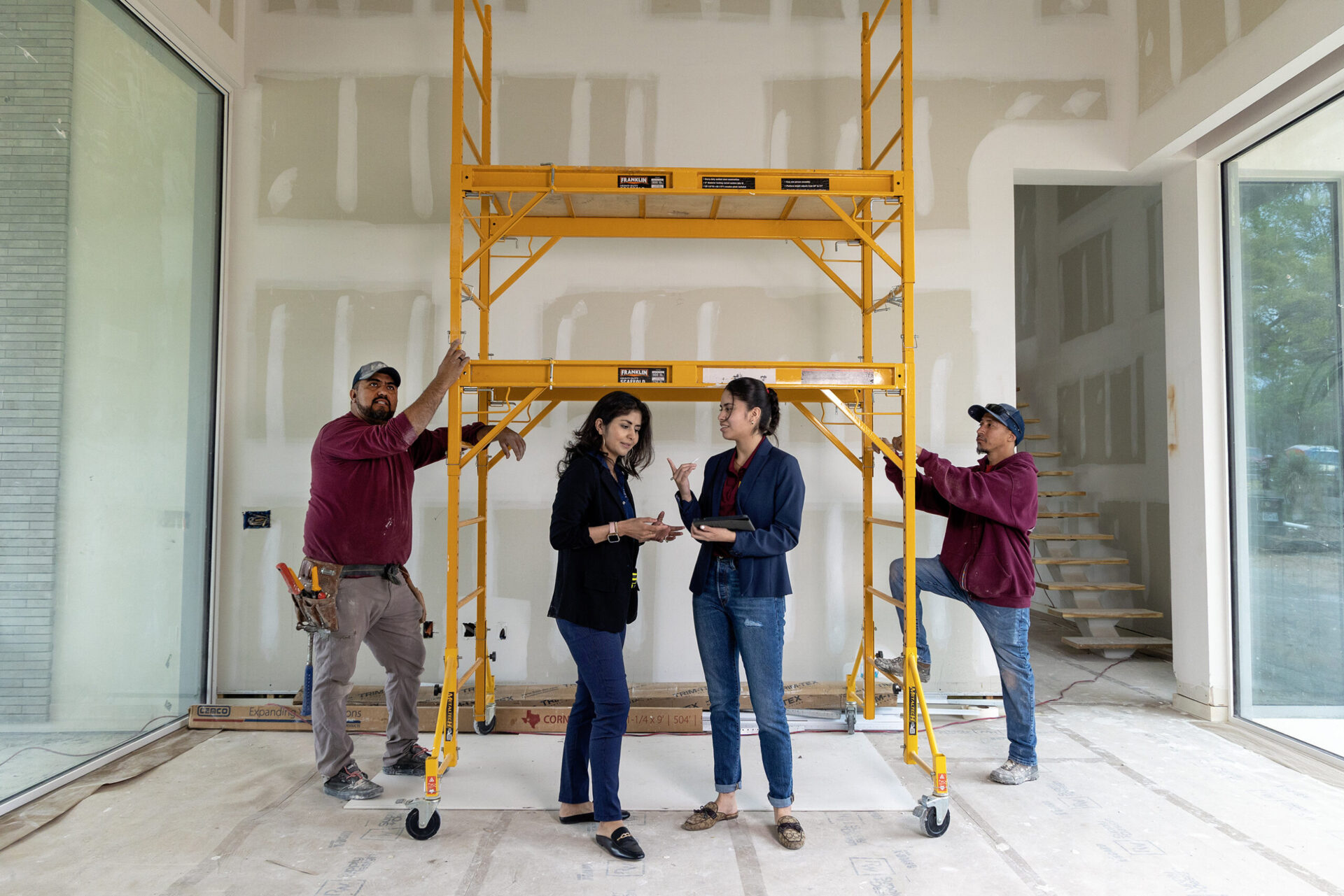 group of construction employees in drywall room