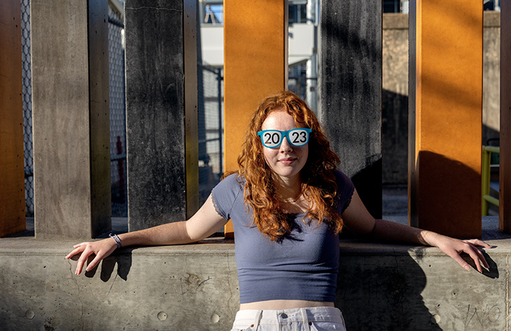 Senior Photo Session with high school girl wearing glasses that say 2023