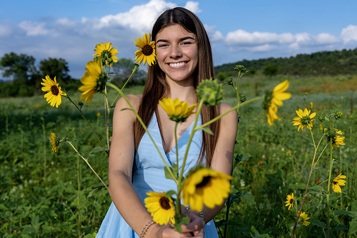 Senior Photo Session at Commons Ford Ranch among the wildflowers and sunflowers in Austin