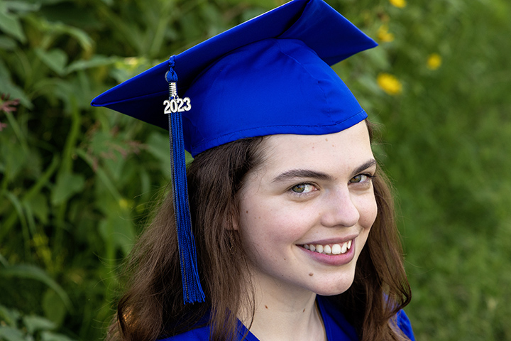 girl in cap and gown for senior photo session 