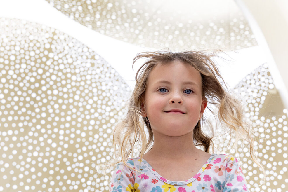 girl at blanton museum under the petal sculptures