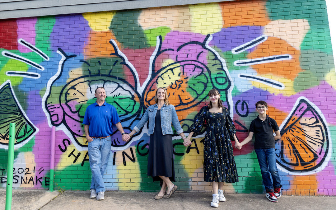 family photo session in front of justin lane colorful murals in austin, texas