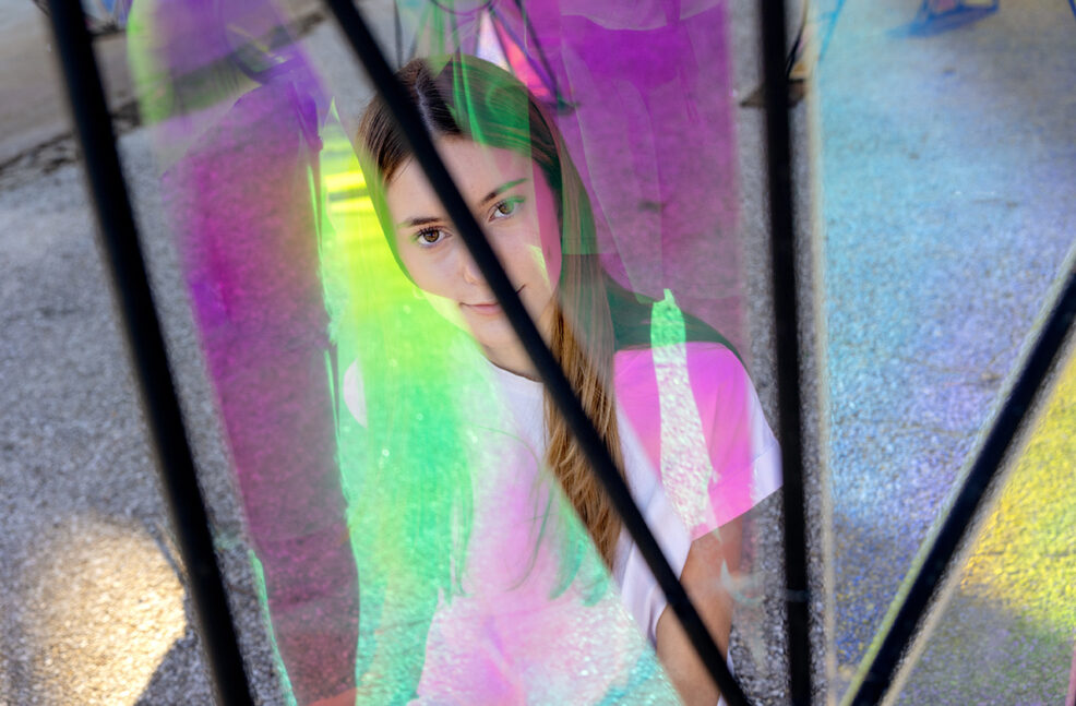 girl in colorful light reflections