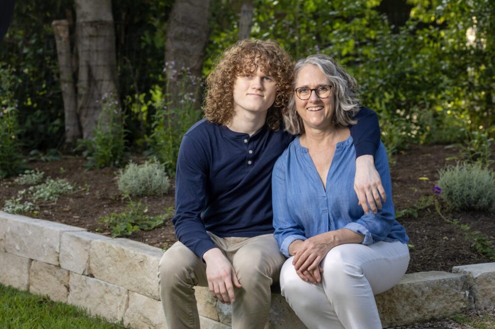 mom and son during senior photo session in their backyard in austin, texas