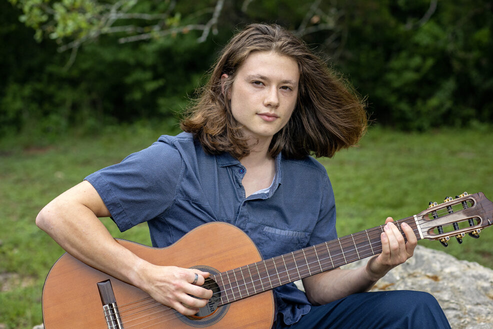 boy senior session playing guitar props to bring