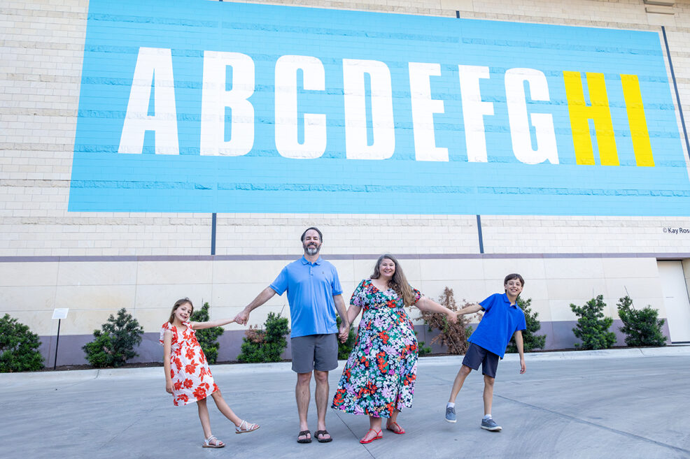 alphabet mural on the blanton museum spring family photo session