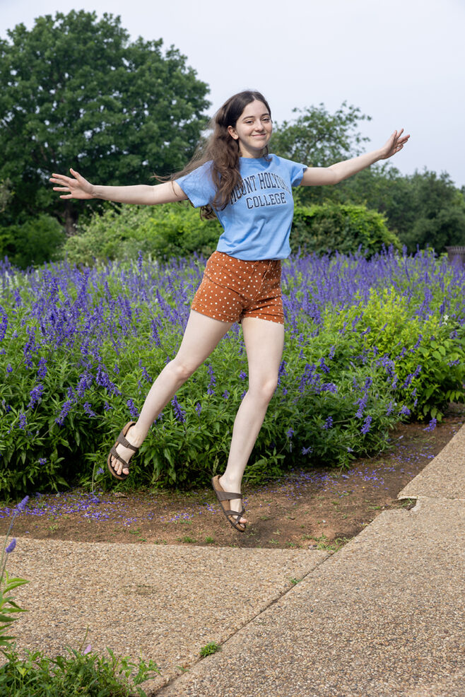 girl jumping wearing her new college t-shirt