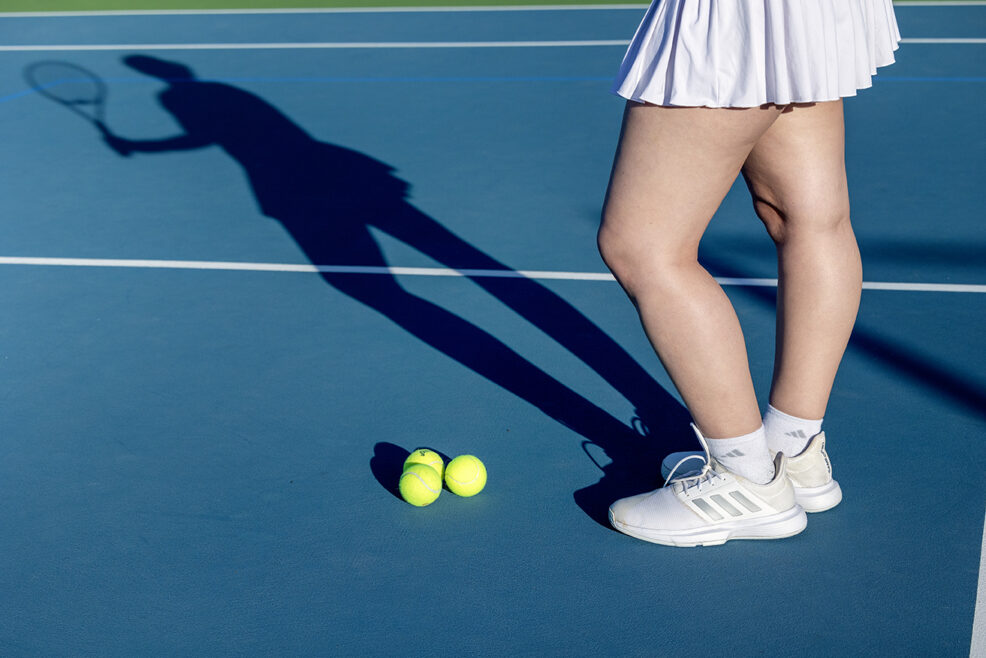 shadow of tennis raquet and tennis balls during sports themed photo session in austin, texas
