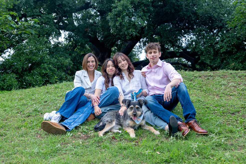 family of four with pet dog during photo session in austin, texas