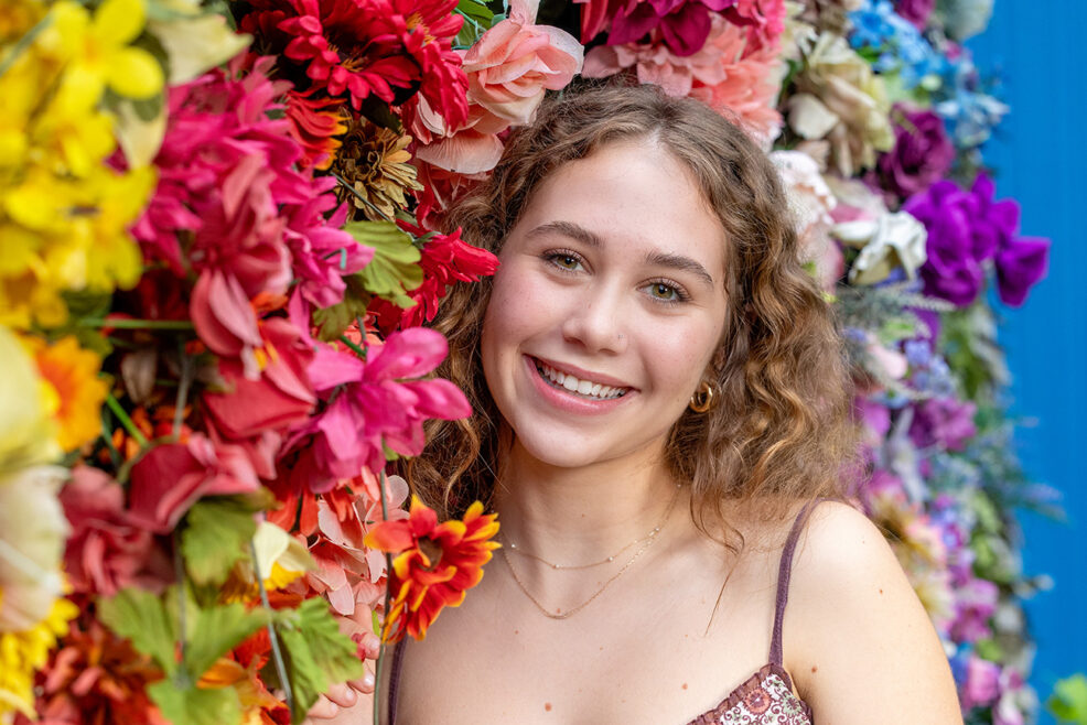 rainbow fake flower wall in high school senior picture session in austin, texas