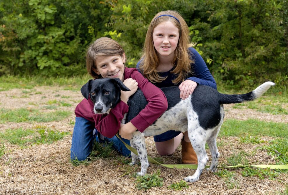 brother and sister with new pet dog