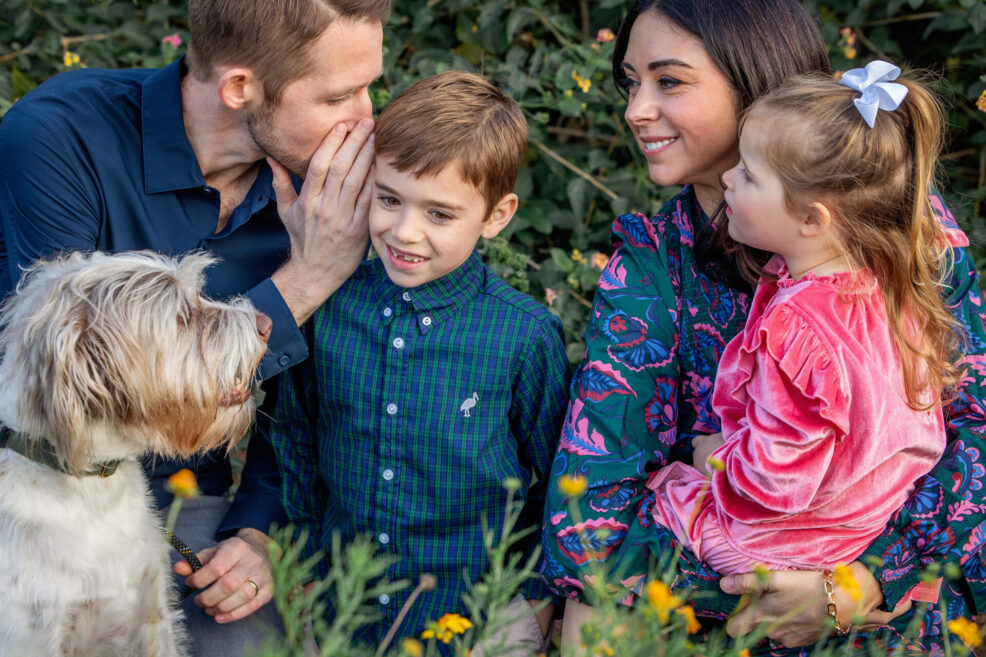family playing the telephone game at photo session in austin