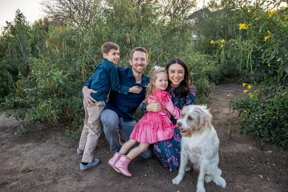 family of four plus their pet dog at mueller greenway park in east austin for a holiday family photo session with stephanie friedman photography