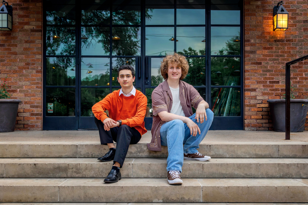 step-brothers sitting on steps at Pease Park for shared senior photo session