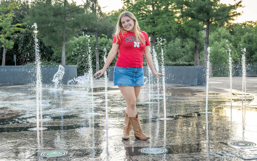 high school senior in the fountain at butler park for her photo session