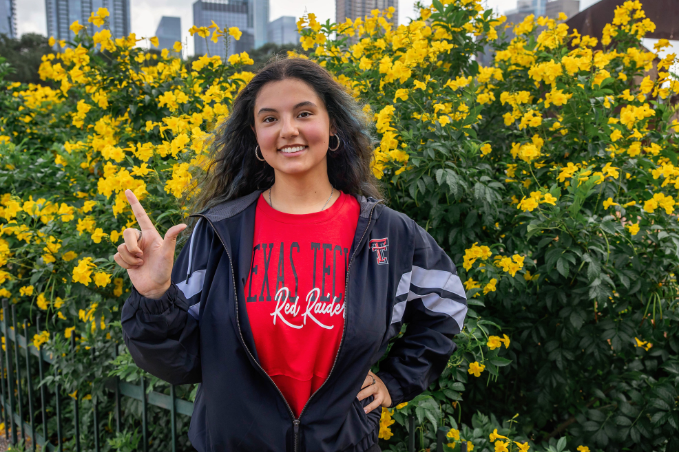 high school senior in texas tech college gear at her photo session at auditorium shores in austin